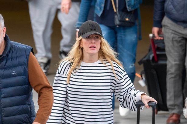 Ellie Goulding lands back in UK after confirming marriage split – and packing on PDA with surfer