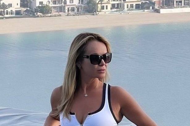 Amanda Holden, 53, is sensational in white bikini as she soaks up the sun with her daughters