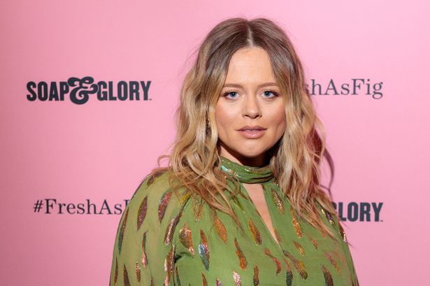 Pregnant Emily Atack glows as she cradles bare baby bump in cut-out dress