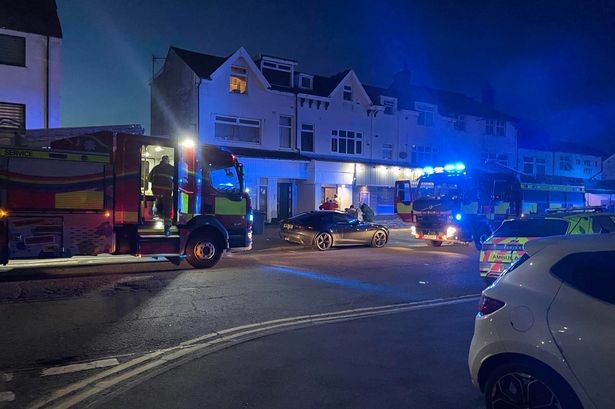 Firefighters rush to cooker blaze in flats above row of shops