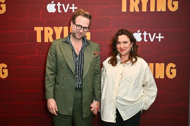 Rafe Spall kisses girlfriend and co-star as she proudly cradles pregnancy bump