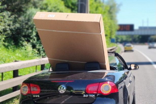 Driver pulled over by police after trying to bring 60-inch TV home in convertible