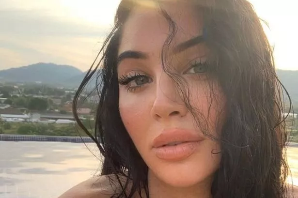 N-Dubz’ Tulisa Contostavlos sizzles in black bikini as she poses on Dubai balcony