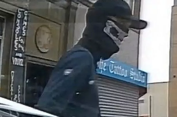 Hunt for ‘man in skull mask’ after paving slab launched into window of police car