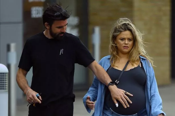 Heavily pregnant Emily Atack looks uncomfortable as she displays huge baby bump on walk with scientist boyfriend