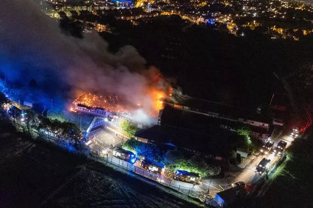 Huge fire service response as blaze tears through building