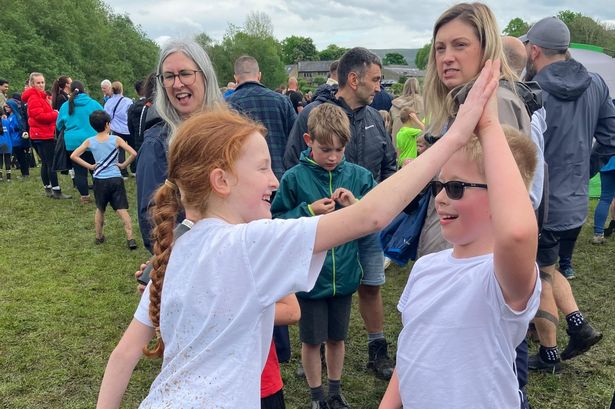 Torrential rain forces last-minute change for 380 triumphant young runners