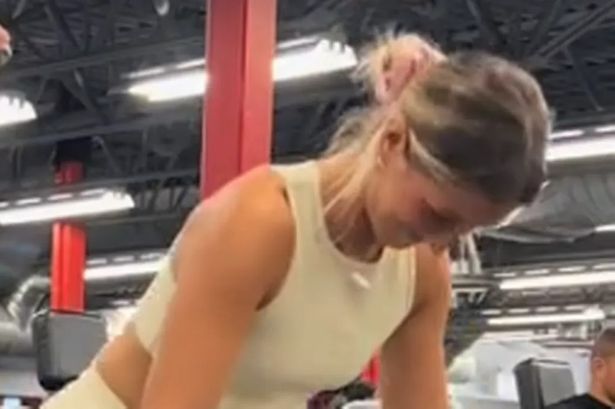 Gym lad put in awkward position as female friend squats in front of him