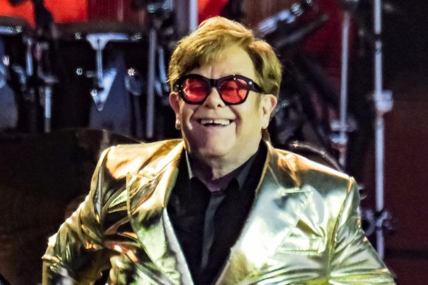 Elton John resorts to using a bottle for relief in a Nice shoe store