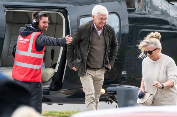 Smiley Phillip Schofield spotted with wife and daughters as they arrive at Grand Prix in style