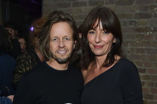 Davina McCall breaks ‘social media silence’ as she poses in gold bikini with rarely-seen boyfriend