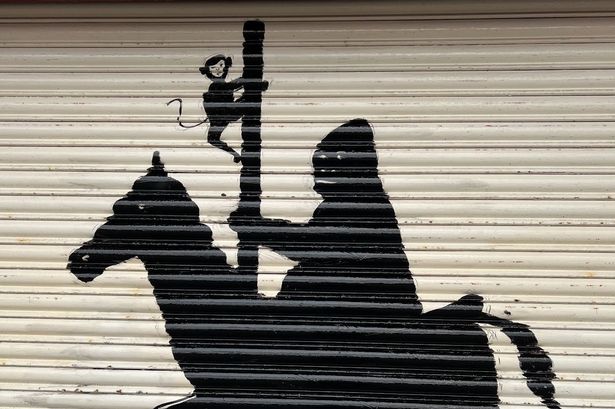 Mystery as Banksy-style street art appears on amusement arcade overnight