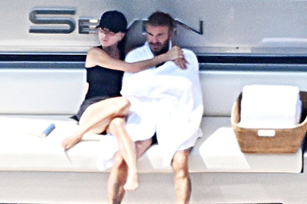 Victoria and David Beckham pack on the PDA as they kiss on board their £16m superyacht – while son Brooklyn is in hospital