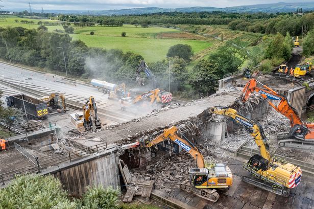 Stunning M62 drone photos show workers pulling down rail bridge over major motorway