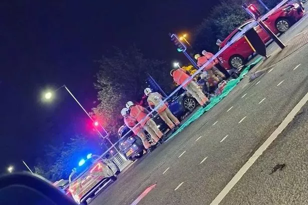 Woman rushed to hospital after three-car crash at busy junction