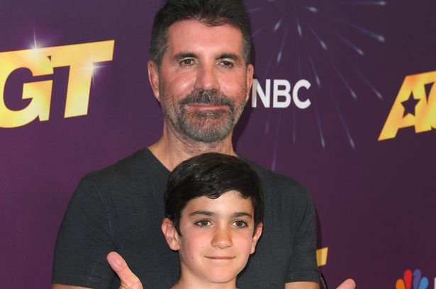 Simon Cowell is a proud dad as he cuddles mini-me son Eric, 10, on red carpet alongside fiancée Lauren Silverman