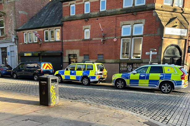 Police and CSI teams swoop on Darwen town centre street and find shotgun and bullets