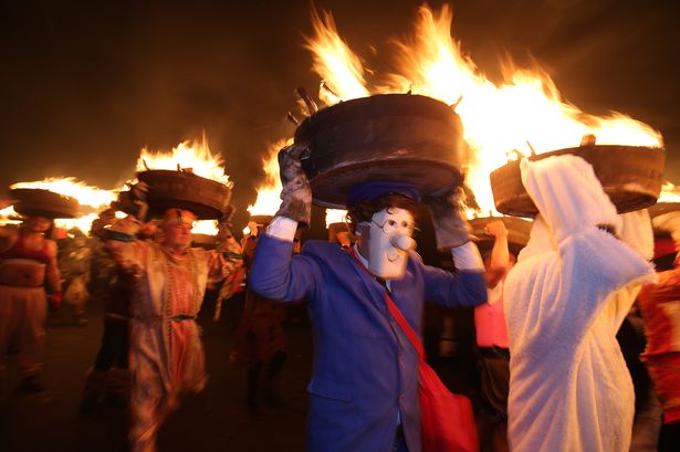 Ancient New Year’s parade where men carry flaming barrels that’s two hours from Lancs