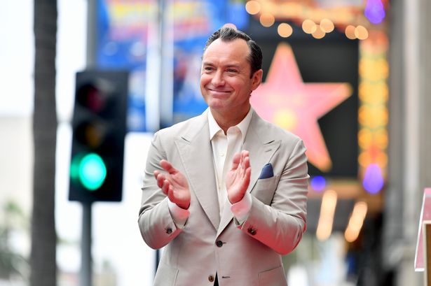 Jude Law’s wife towers above him as he proudly poses with rarely-seen children for major honour