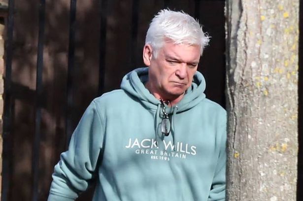 Phillip Schofield looks downcast as he takes bins out as Holly Willoughby’s Netflix show launches