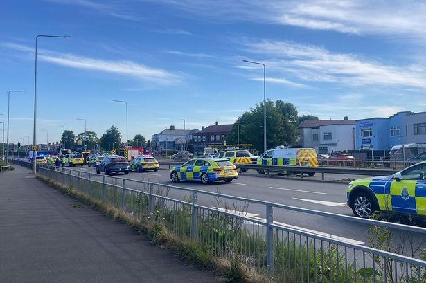 Man killed in crash on major road outside Aldi with huge cordon in place