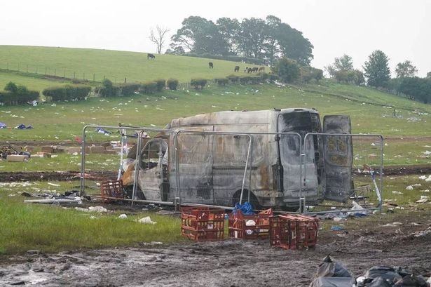 Fields covered in rubbish and a van burnt out seen after Appleby horse fair