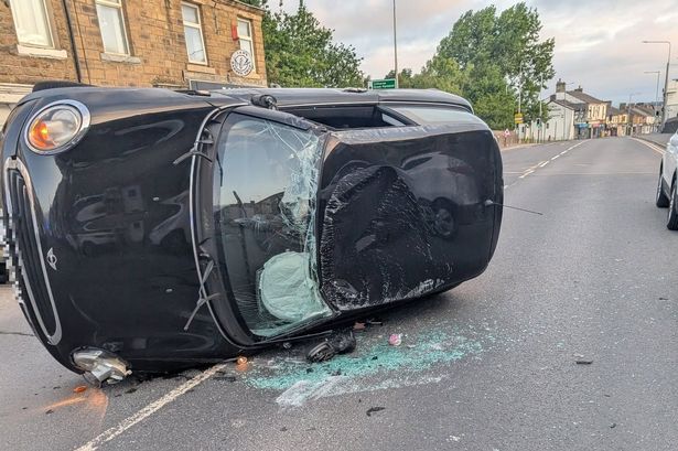 Dramatic moment car flips onto its side in crash as major road blocked