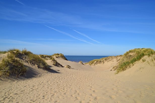 Naked man spotted in sand dunes among those flouting beach rules