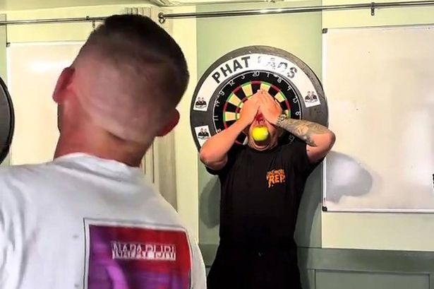 Darts star Nathan Aspinall performs ‘William Tell’ stunt with influencer