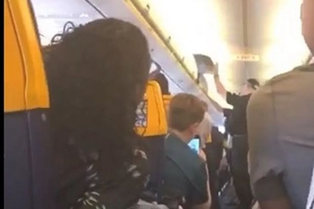 Moment police storm Ryanair flight after passenger ‘tries to open emergency exit’ mid-air