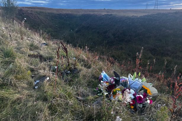 Boy, 17, killed after car plunged down embankment named by friends as floral tributes left at scene