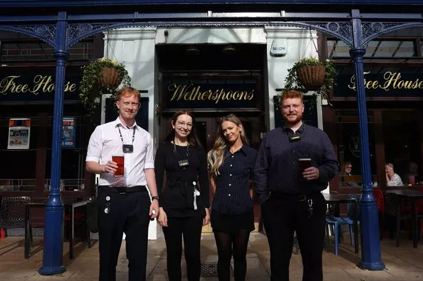 Inside the busy Wetherspoons where staff relax with customers over biscuits
