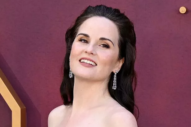 Downton Abbey star Michelle Dockery pregnant with first child as she debuts bump at premiere