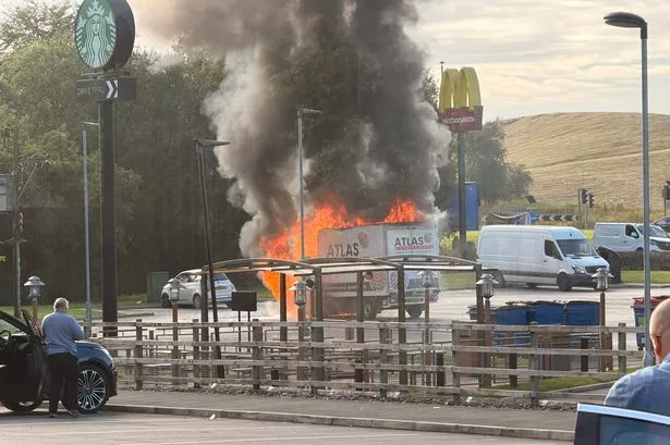 Fire crews rush to McDonald’s car park after van goes up in flames