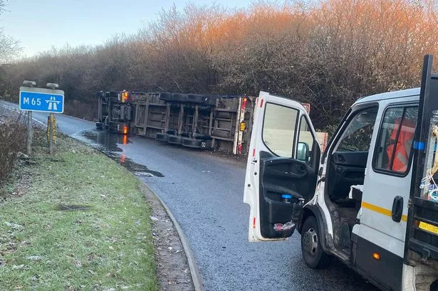 Live M65 traffic updates as lorry overturns on exit slip road causing long delays