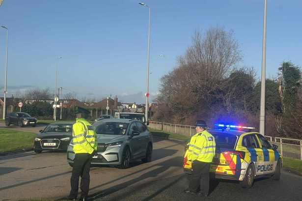Busy road blocked after police called to car crash at junction