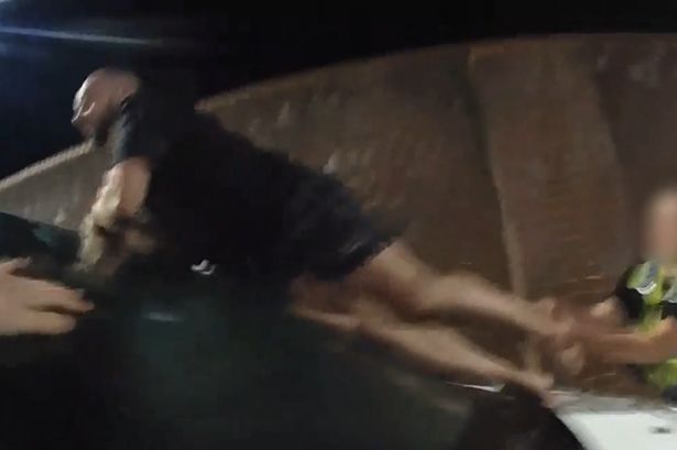 Moment suspect leaps onto police van shouting ‘I’m not going to jail – I’m not going back’