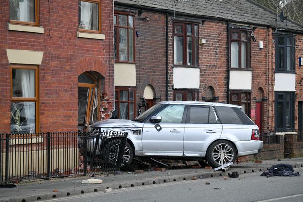 Road cordoned off after Range Rover crashes into Bolton house