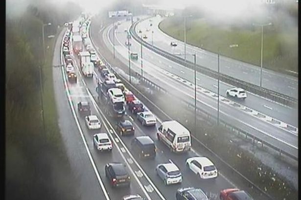 Woman rushed to hospital with life-threatening injuries as M61 shut for hours