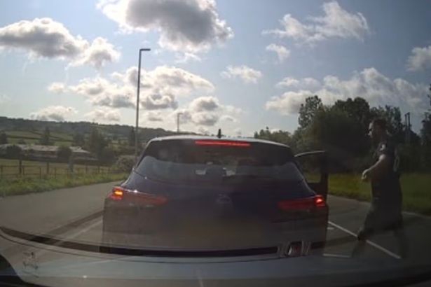 Video shows angry driver punch man unconscious in front of his wife and kids