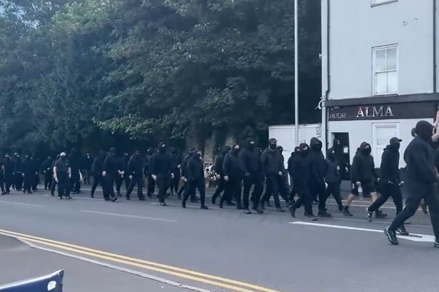 Black-clad masked ‘stop the boats’ protesters block roads in Dover
